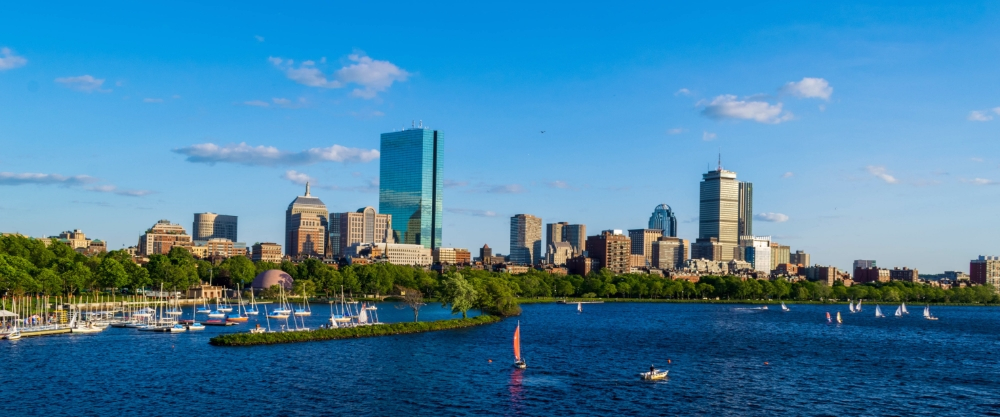 Skyline of Boston, Massachusetts, home to Harvard and MIT, showing the Charles River and the city's modern architecture.